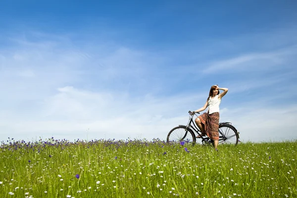 Girl with a bicycle — Stock Photo, Image
