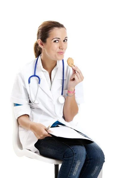 Nurse eating a cookie — Zdjęcie stockowe