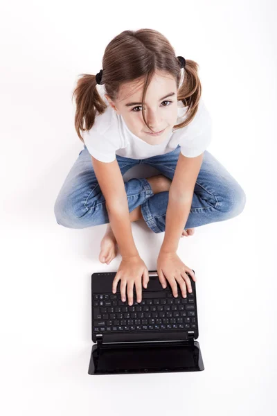 Little student girl with a laptop — Stock Photo, Image