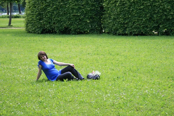 stock image Pregnant woman resting on grass