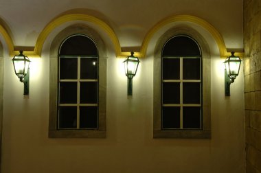 Facade of windows and antique lanterns clipart