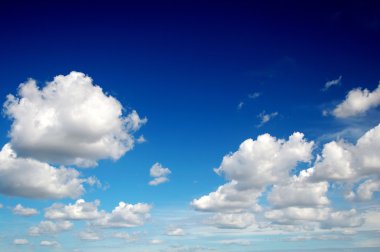 Blue sky with cotton like clouds clipart