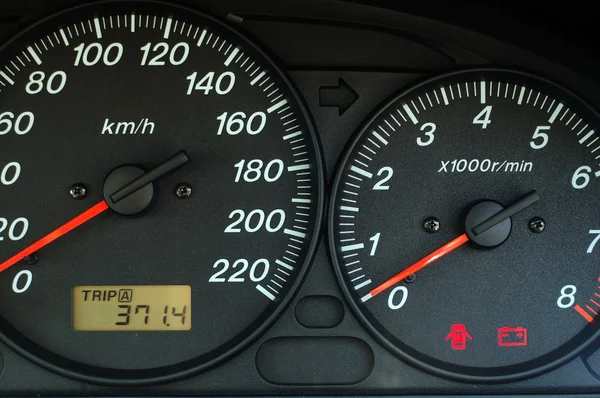 Car dashboard with speed and rpm dials — Stock Photo, Image