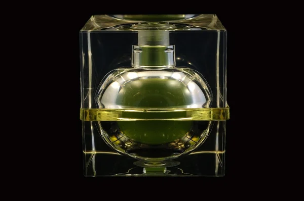 stock image Bottle of perfume over black background