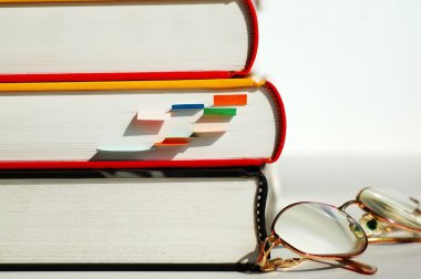 Three books and glasses clipart