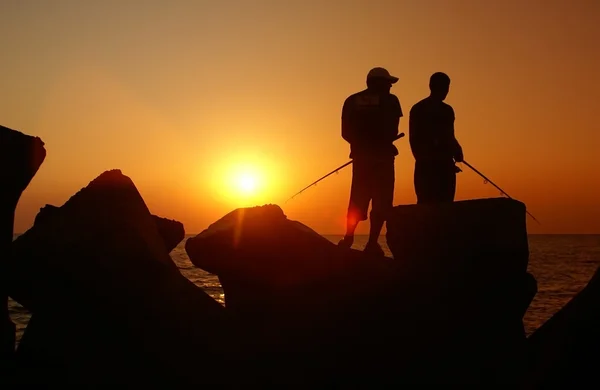 Halászat napkeltekor Stock Fotó