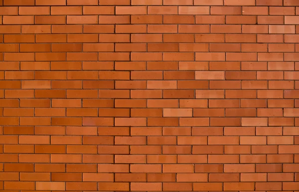Un muro di mattoni rosso-arancio — Foto Stock