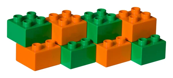 Tijolos de brinquedo de plástico verde e laranja — Fotografia de Stock
