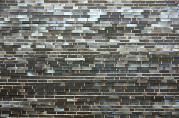 Uma parede de tijolo escuro — Fotografia de Stock