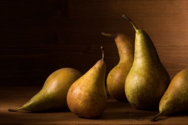Composition of pears on wooden table clipart