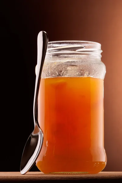 Apricot jam and tea spoon — Stock Photo, Image