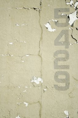 Numbers stenciled on old wall background texture clipart