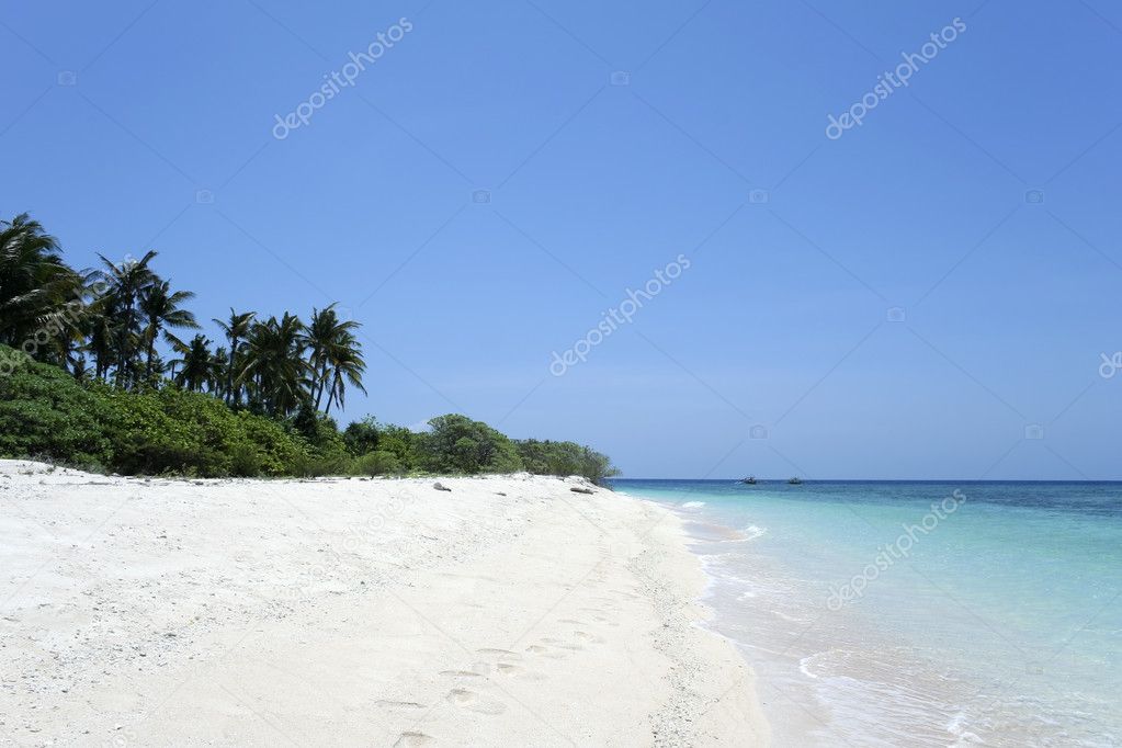 Desert island white sand beach blue sky background