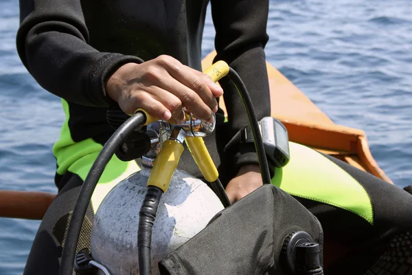 stock image Go dive scuba diver handling tank and regulator on outrigger canoe