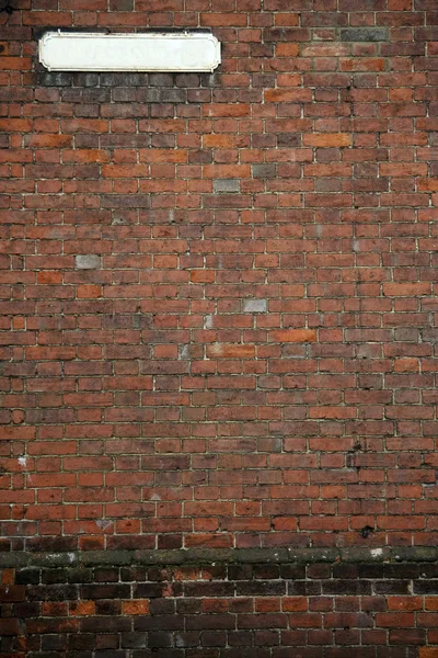 Vecchio cartello stradale muro di mattoni — Foto Stock