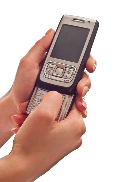 Teléfono móvil de plata en las manos — Foto de Stock