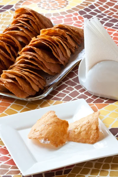 Pastry cakes with sugar on plate.