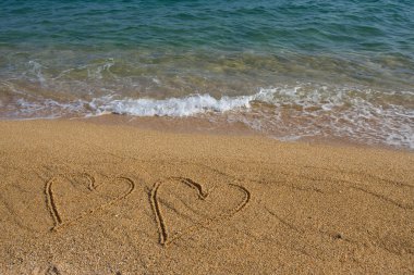 Two hearts on the beach. clipart