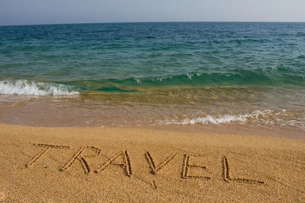 stock image Word travel on the beach.