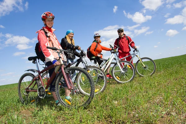 一群骑自行车在农村四个成年人 图库图片