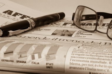 Glassess and pen on financial newspaper clipart