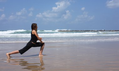 Woman during fitness on sea beach clipart