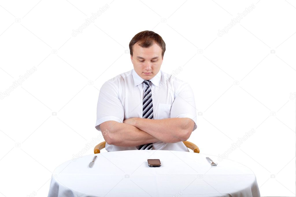 Business man seat before a table with phone
