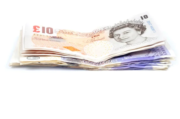 Högen av britisch pounds på vit bakgrund med — Stockfoto