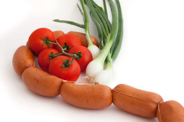 Свежие сырые овощи и колбаса на белом фоне — стоковое фото