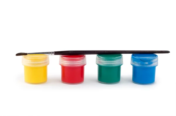 Guaj boya tenekeleri ve fırça — Stok fotoğraf