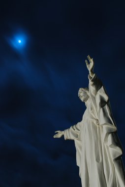 Moon beyond Jesus Christ statue clipart