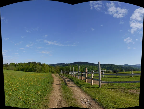 Mountain meadow with fence — Stock Photo, Image