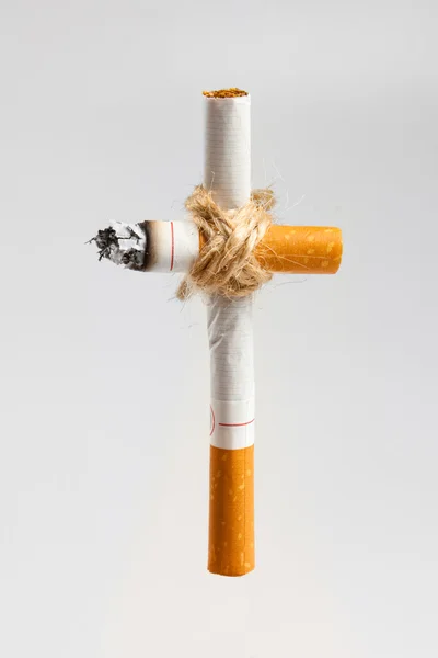 Graveyard cross from cigarettes — Stock Photo, Image