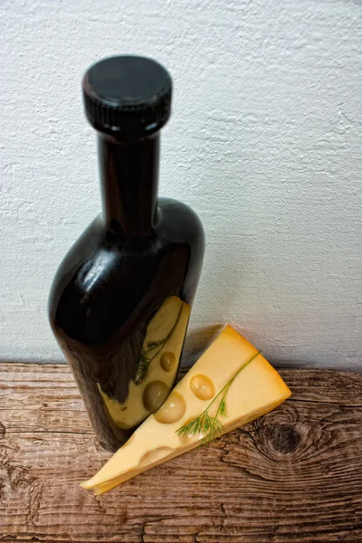 Bottle of wine and cheese on the background wall — Stock Photo, Image