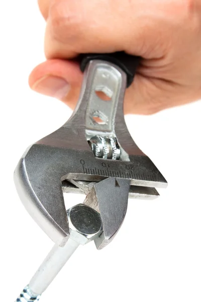 Schraubenschlüssel mit der Schraube in der Hand — Stockfoto