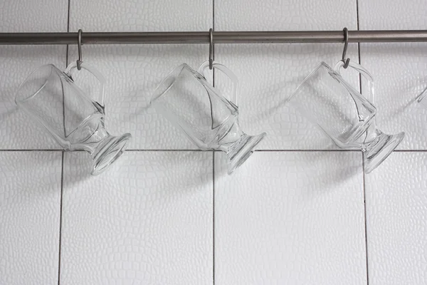 Glasses hanging on hooks — Stock Photo, Image