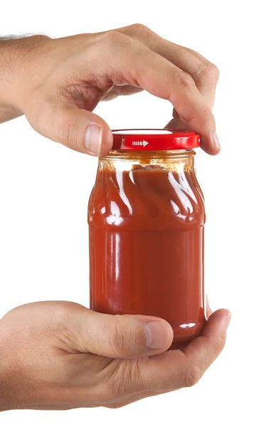 Jar tomato paste in hand — Stock Photo, Image