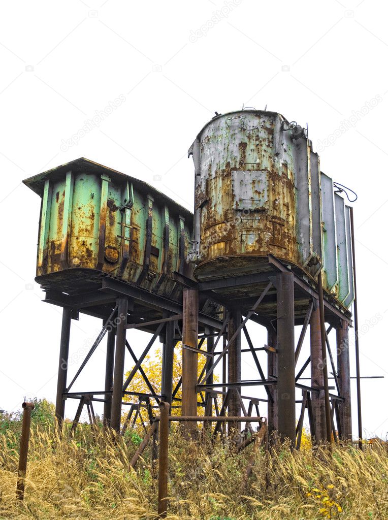 Two rusty old industrial barrels