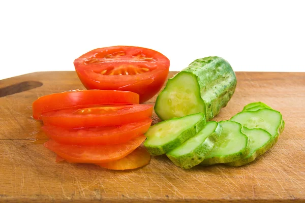 Rodajas de pepino y tomate en una tabla de cortar —  Fotos de Stock