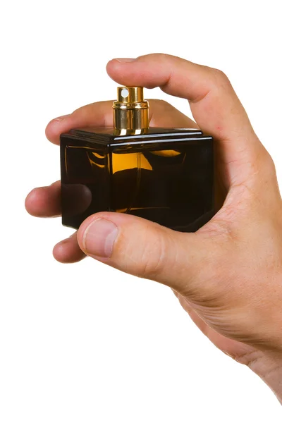 Bottle of cologne in his hand — Stock Photo, Image