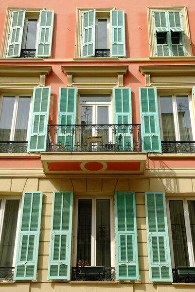 Street view of a typical pastel colored house at the Cote Azur with mediterranean appeal.