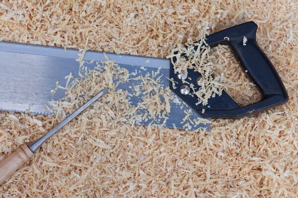Wood shavings handsaw and chisel