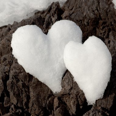 Two snow hearts on rock clipart