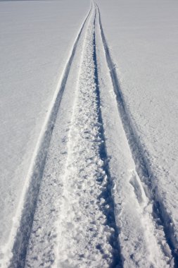 Skidoo track in fresh clean snow clipart