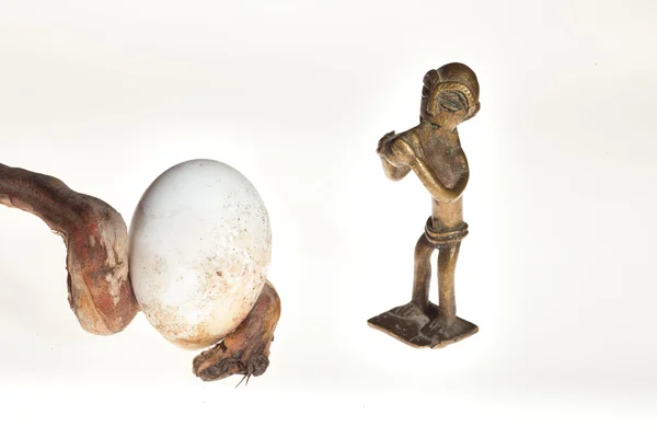 Flutist sculpture and egg — Stock Photo, Image