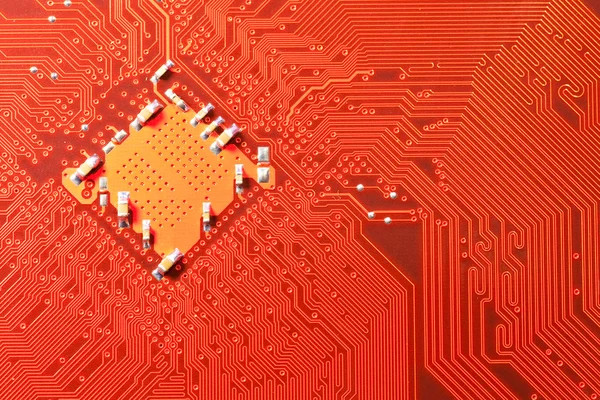 Closeup of computer circuit board in orange — Stock Photo, Image