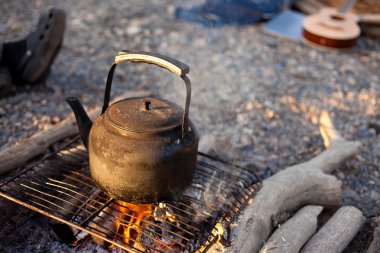 Waiting for coffee at the campfire clipart