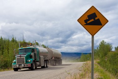 Fuel truck on steep dirt road clipart