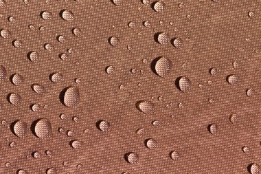 Droplets on brown fabric clipart