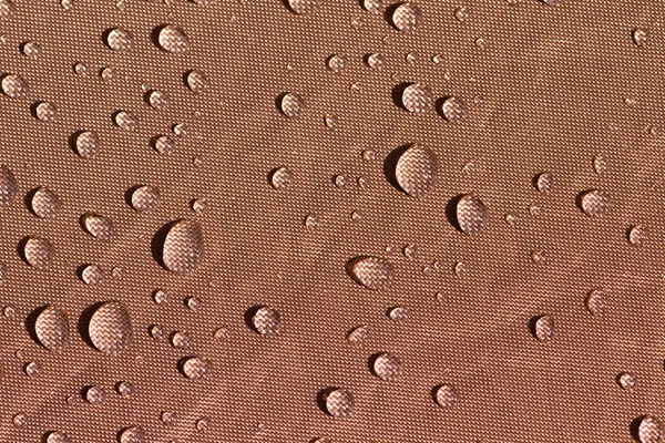 Droplets on brown fabric — Stock Photo, Image